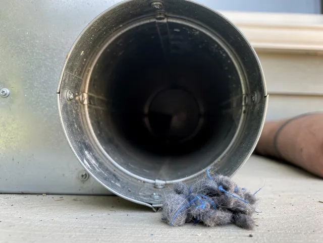 Tallmadge Dryer Vent Cleaning technician using specialized equipment to clear severe dryer vent blockage in Tallmadge